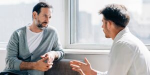 A man talks with a therapist to support the process of weening off Suboxone.